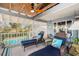 Relaxing covered deck with lounge chairs and additional seating, ideal for waterfront living at 9920 Alavista Dr, Gibsonton, FL 33534
