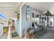 Charming outdoor patio with dining area, decor, and a refreshing blue door at 9920 Alavista Dr, Gibsonton, FL 33534