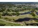 Aerial view of a golf course with lush green fairways and scenic water hazards and ponds at 10064 82Nd St, Seminole, FL 33777
