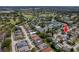 Aerial view of the property in a neighborhood featuring lush landscaping, pools and tennis courts at 10064 82Nd St, Seminole, FL 33777