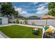 Beautifully landscaped backyard with artificial turf and paved walkway leading to seating area at 10064 82Nd St, Seminole, FL 33777