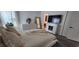Cozy bedroom with a decorative mirror, dresser, and tv over fireplace at 10064 82Nd St, Seminole, FL 33777