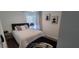 Well-lit bedroom with a bed, nightstand, and decorative wall art at 10064 82Nd St, Seminole, FL 33777