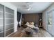 Stylistically designed bedroom with an accent wall, plush furniture, and sliding glass doors to outside at 10064 82Nd St, Seminole, FL 33777