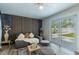 Stylistically designed bedroom with an accent wall, plush furniture, and sliding glass doors to outside at 10064 82Nd St, Seminole, FL 33777