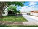 Charming single Gathering home with a well-maintained lawn, lush trees and extended driveway at 10064 82Nd St, Seminole, FL 33777