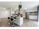 Modern, updated kitchen with island, stainless steel appliances, and gray wood flooring at 10064 82Nd St, Seminole, FL 33777