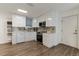 Modern kitchen featuring white cabinetry, stainless steel appliances, and tile backsplash at 10064 82Nd St, Seminole, FL 33777