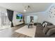Comfortable living room featuring modern decor, a ceiling fan, and seamless flow into the bedroom at 10064 82Nd St, Seminole, FL 33777