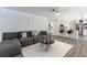 Comfortable living room featuring modern decor, a ceiling fan, and seamless flow into the kitchen at 10064 82Nd St, Seminole, FL 33777