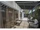 Relaxing patio features comfortable wicker seating, neutral rug and privacy wall with green plants at 10064 82Nd St, Seminole, FL 33777