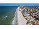 Beautiful aerial view of the beach, ocean, and beach residences on a sunny day at 102 23Rd St, Belleair Beach, FL 33786