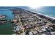 Stunning aerial view showcases beach and bay side neighborhood, perfect for vacationing at 102 23Rd St, Belleair Beach, FL 33786