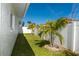 Grassy backyard features a privacy fence and tropical landscaping at 102 23Rd St, Belleair Beach, FL 33786