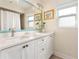 Bright bathroom with a double vanity, white cabinetry, and decorative accents at 102 23Rd St, Belleair Beach, FL 33786