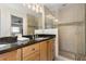 Beautiful bathroom featuring a tiled shower, granite countertops and wood cabinetry at 102 23Rd St, Belleair Beach, FL 33786