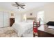 Cozy bedroom with white bedding, ceiling fan, and natural light from two windows at 102 23Rd St, Belleair Beach, FL 33786