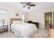 Bright bedroom with wood-look floors, a ceiling fan, and a well-lit workspace at 102 23Rd St, Belleair Beach, FL 33786