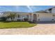 Charming home with a paved driveway and lush landscaping at 102 23Rd St, Belleair Beach, FL 33786