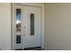 Close-up of a white front door with decorative glass and a textured wall at 102 23Rd St, Belleair Beach, FL 33786