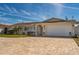 Lovely single-story home with a brick driveway leading to a two-car garage at 102 23Rd St, Belleair Beach, FL 33786