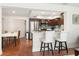 An open concept kitchen featuring modern appliances, stainless steel fridge, and breakfast bar seating at 102 23Rd St, Belleair Beach, FL 33786