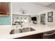 Modern kitchen featuring a stainless steel sink and view to the living room at 102 23Rd St, Belleair Beach, FL 33786