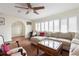 Cozy living area with a large sofa, shuttered windows and tile floors at 102 23Rd St, Belleair Beach, FL 33786