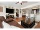 Open living room featuring a leather couch, TV, and adjacent kitchen and dining area at 102 23Rd St, Belleair Beach, FL 33786