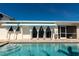 Home boasts a beautiful pool with awnings and access to the house at 102 23Rd St, Belleair Beach, FL 33786