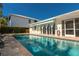 Relaxing pool area with sparkling swimming pool and covered outdoor patio for entertaining at 102 23Rd St, Belleair Beach, FL 33786