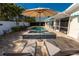 Inviting private pool with tiled spa, lounge chairs, and umbrella for ultimate relaxation at 102 23Rd St, Belleair Beach, FL 33786