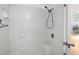 Bright bathroom featuring a stand-up shower with white tile, and updated fixtures at 10467 Larchmont N Pl, Pinellas Park, FL 33782