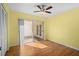 Sunlit bedroom with laminate floors, large closet, and sliding glass doors to patio at 10467 Larchmont N Pl, Pinellas Park, FL 33782