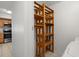 Laundry closet with custom wood shelving that offers lots of extra storage space at 10467 Larchmont N Pl, Pinellas Park, FL 33782