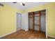 Bedroom closet with custom wooden shelving for plenty of storage, yellow walls at 10467 Larchmont N Pl, Pinellas Park, FL 33782