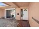 Inviting porch with a patterned brick floor, sliding glass doors, and a white front door at 10467 Larchmont N Pl, Pinellas Park, FL 33782
