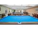 Spacious recreation room featuring billiards tables, chairs, and community games at 10467 Larchmont N Pl, Pinellas Park, FL 33782