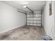 Attached garage with a concrete floor and a white door; plenty of space for parking at 10467 Larchmont N Pl, Pinellas Park, FL 33782