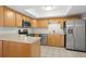 Bright kitchen with wood cabinets, stainless steel appliances, and tiled floor at 10467 Larchmont N Pl, Pinellas Park, FL 33782