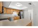 Modern kitchen with stainless steel appliances, tile backsplash, bright lighting and ample countertop space at 10467 Larchmont N Pl, Pinellas Park, FL 33782