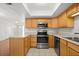 Modern kitchen featuring stainless appliances, light wood cabinets, and tile floors at 10467 Larchmont N Pl, Pinellas Park, FL 33782