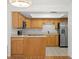 Updated kitchen with wood cabinets, stainless appliances, and tiled floor at 10467 Larchmont N Pl, Pinellas Park, FL 33782