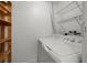 Laundry room with washer, dryer, and wire shelving for organizing storage at 10467 Larchmont N Pl, Pinellas Park, FL 33782