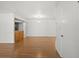 Open living space with hardwood floors and view into the kitchen at 10467 Larchmont N Pl, Pinellas Park, FL 33782