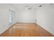 Bright living room with hardwood floors, modern lighting, and french doors at 10467 Larchmont N Pl, Pinellas Park, FL 33782