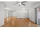 Bright living room with hardwood floors, ceiling fan, and sliding doors to back porch at 10467 Larchmont N Pl, Pinellas Park, FL 33782