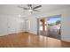 Bright living room with hardwood floors, ceiling fan, and sliding doors to back porch at 10467 Larchmont N Pl, Pinellas Park, FL 33782