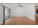 Open living space featuring hardwood floors, sliding glass doors, and a ceiling fan at 10467 Larchmont N Pl, Pinellas Park, FL 33782