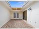 Enclosed brick patio with covered skylight and double doors at 10467 Larchmont N Pl, Pinellas Park, FL 33782